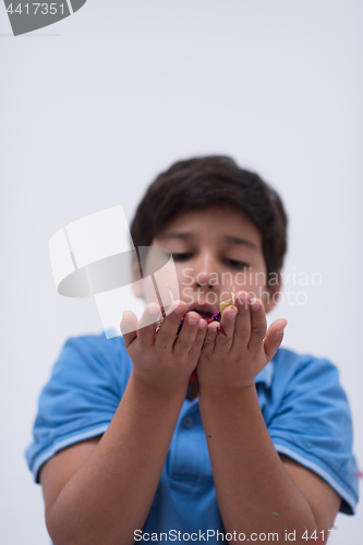 Image of kid blowing confetti