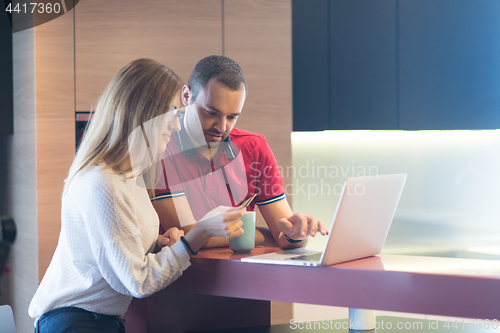 Image of happy young couple buying online