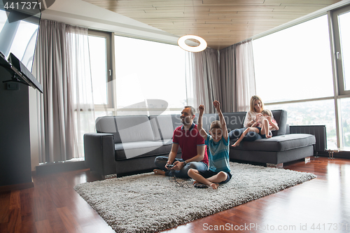 Image of Happy family playing a video game