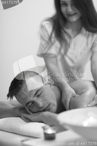 Image of young man having a back massage