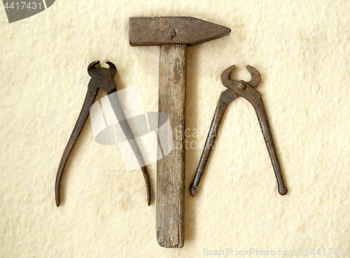 Image of old hammer and two old nippers