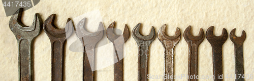 Image of rusty old wrenches photographed to half