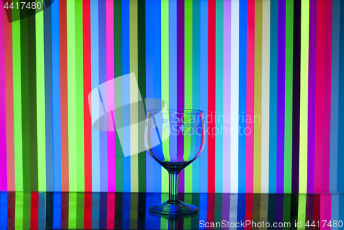 Image of glass goblet on stripes background