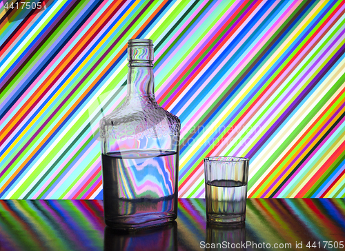 Image of half a bottle of vodka and glasses