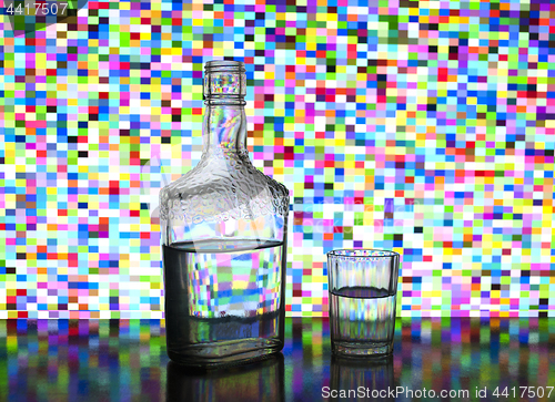 Image of transparent glass bottle filled with vodka