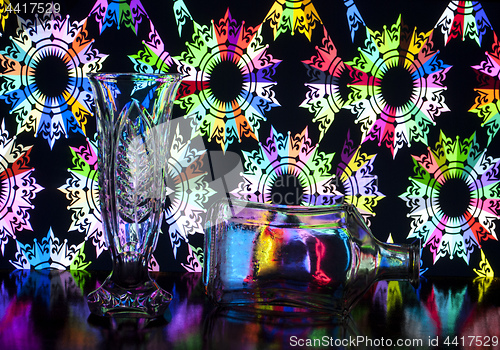 Image of glass vase and bottle on background