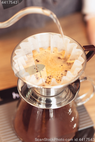 Image of Hand drip coffee, Barista pouring water on coffee ground with filter