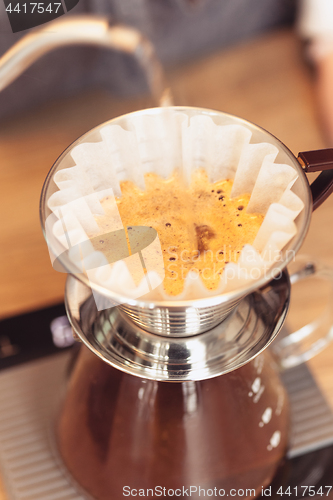 Image of Hand drip coffee, Barista pouring water on coffee ground with filter