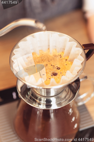 Image of Hand drip coffee, Barista pouring water on coffee ground with filter