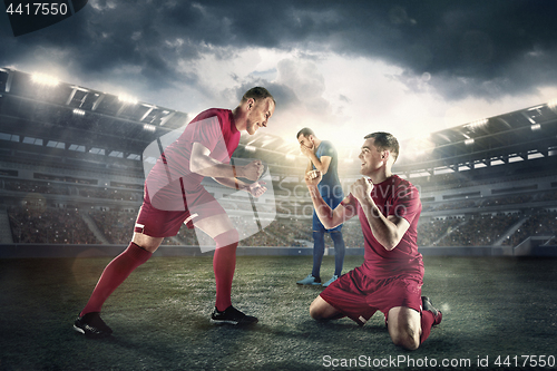 Image of Happiness football players after goal on the field of stadium