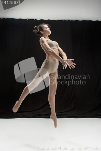 Image of Young teen dancer on white floor background.