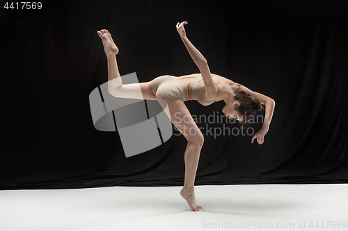 Image of Young teen dancer on white floor background.