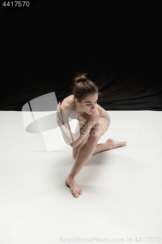 Image of Young teen dancer on white floor background.