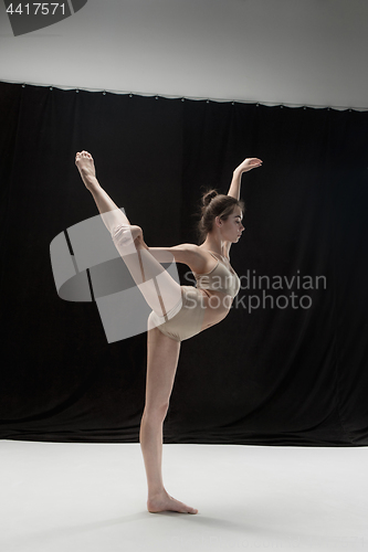 Image of Young teen dancer on white floor background.