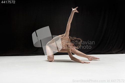 Image of Young teen dancer on white floor background.
