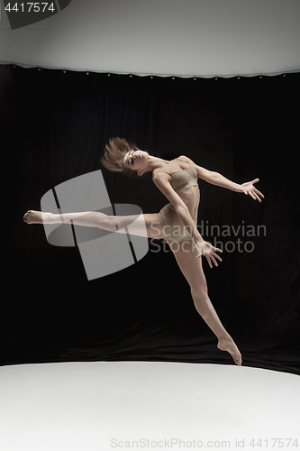 Image of Young teen dancer on white floor background.