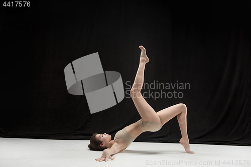 Image of Young teen dancer on white floor background.