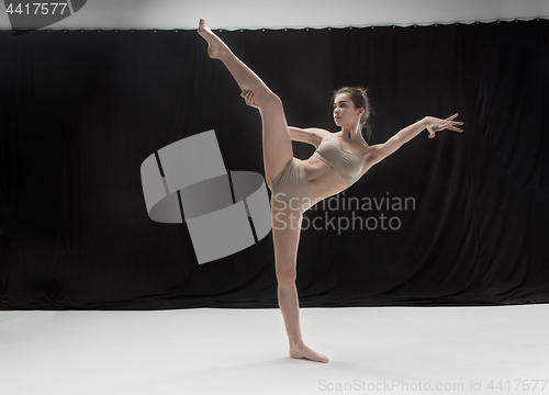 Image of Young teen dancer on white floor background.