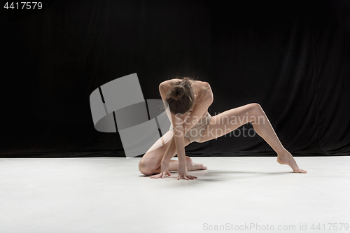 Image of Young teen dancer on white floor background.