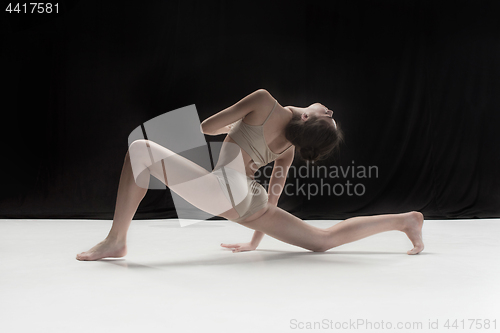 Image of Young teen dancer on white floor background.