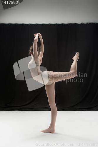 Image of Young teen dancer on white floor background.