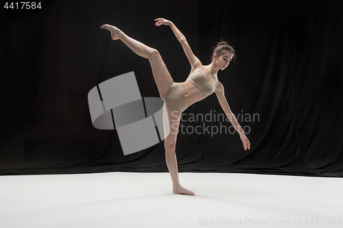 Image of Young teen dancer on white floor background.