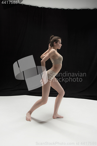 Image of Young teen dancer on white floor background.