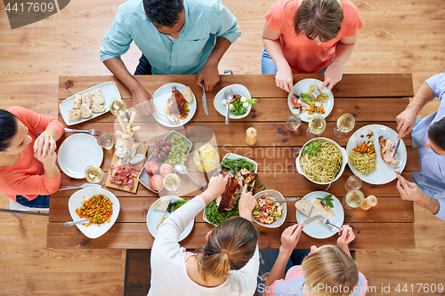 Image of group of people eating chicken for dinner