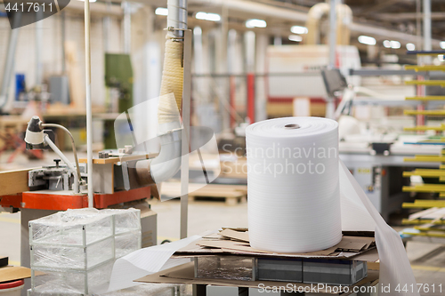 Image of roll of foam wrap at woodworking factory workshop