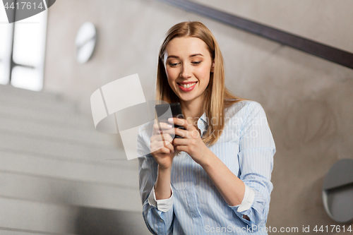 Image of woman or student with smartphone at office stairs