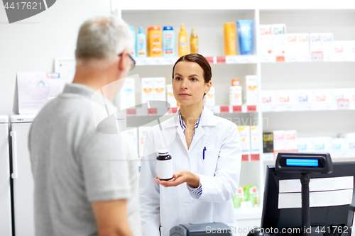 Image of apothecary and senior customer at pharmacy