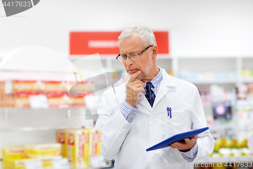 Image of senior with tablet pc at pharmacy