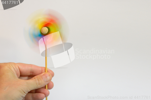 Image of Multi-colored windmill and hand