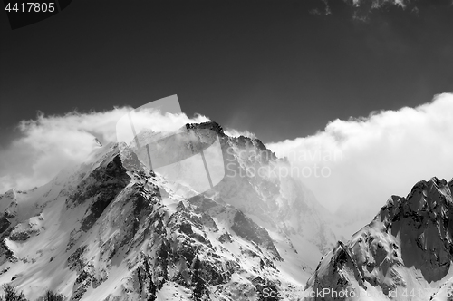 Image of Black and white view on snow winter mountains in clouds