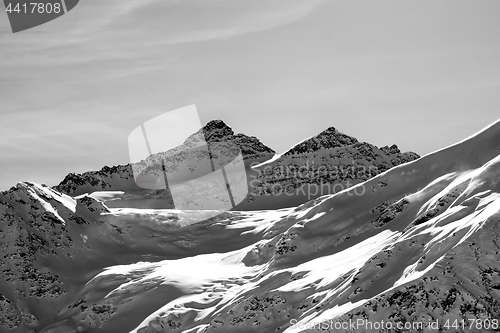 Image of Black and white view on winter mountains with snow cornice at su