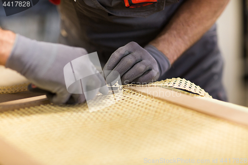 Image of assembler with cutter making furniture