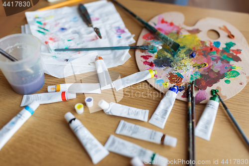 Image of palette, brushes and paint tubes on table