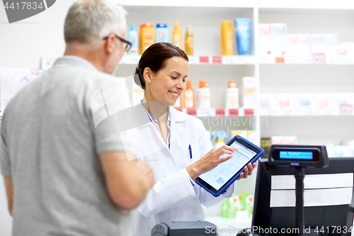 Image of apothecary and customer with tablet pc at pharmacy