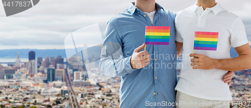 Image of male couple with gay pride flags at san francisco