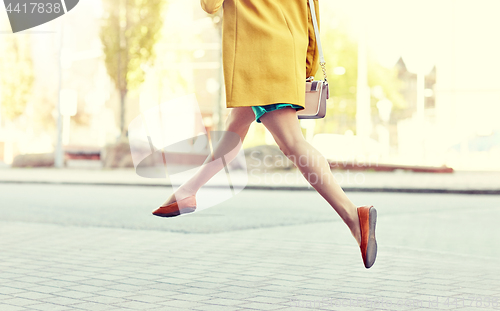 Image of young woman or teenage girl legs on city street