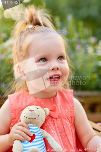 Image of portrait of happy beautiful little girl outdoors