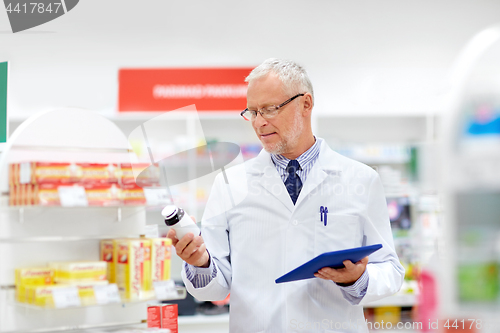 Image of senior with tablet pc at pharmacy