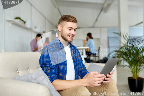 Image of man with tablet pc working at office