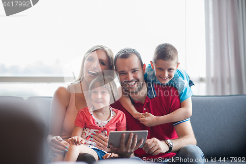 Image of happy young couple spending time with kids