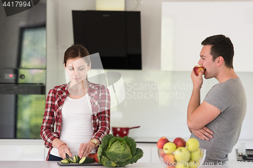 Image of Young handsome couple in the kitchen