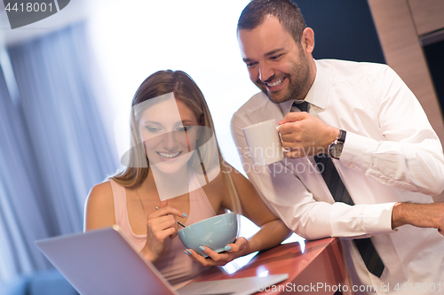 Image of A young couple is preparing for a job and using a laptop