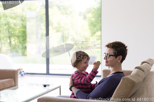 Image of mother and cute little girl enjoying their free time