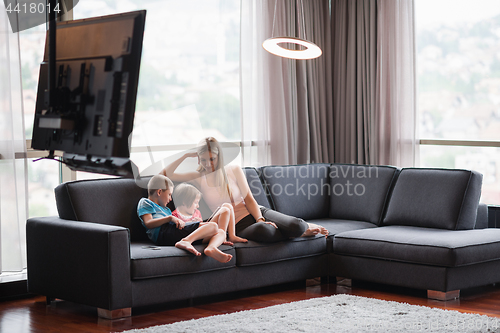 Image of young mother spending time with kids