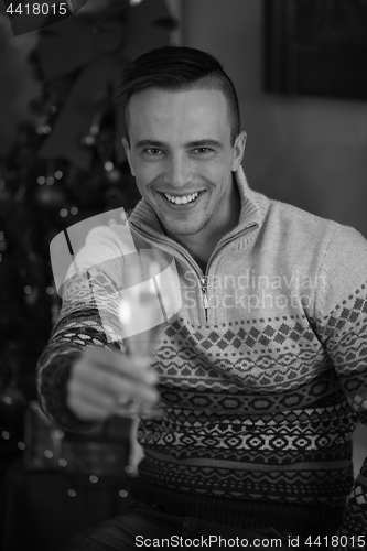 Image of Happy young man with a glass of champagne