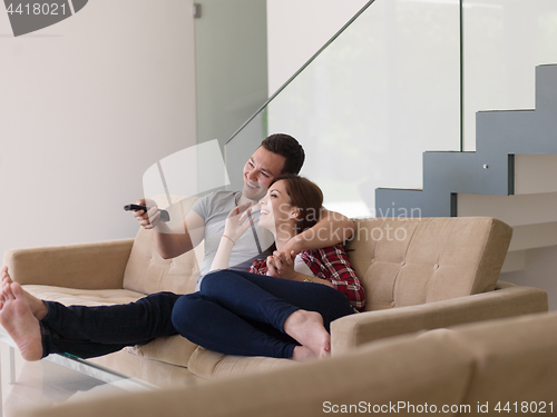 Image of Young couple on the sofa watching television